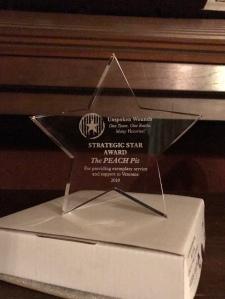 Acrylic star with "Strategic Star Award" and "The PEACH Pit" etched in it.